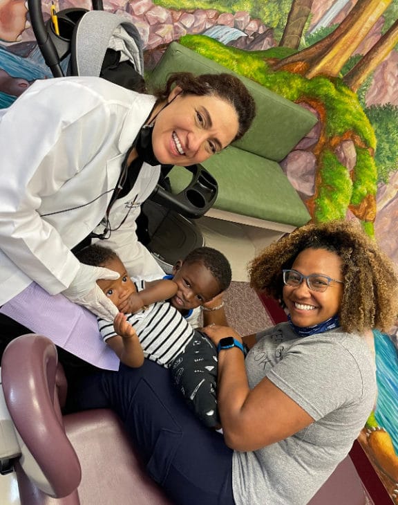 Dr. Marzieh Zahedi with a young patient at Azari & Zahedi Dentistry, Jacksonville FL