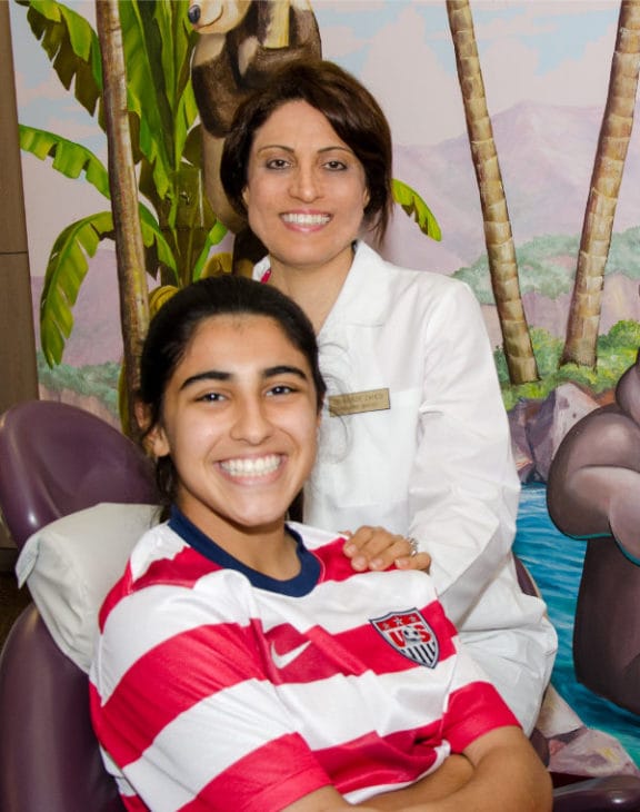 Dr. Zahedi providing orthodontic care to a young patient in Jacksonville